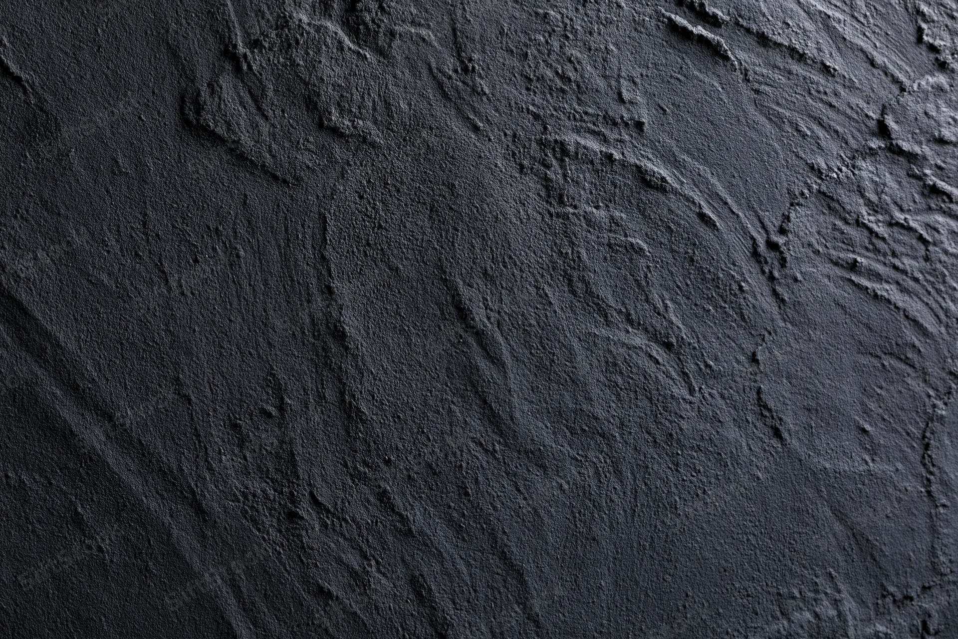 Dark textured concrete wall in close-up flat lay view
