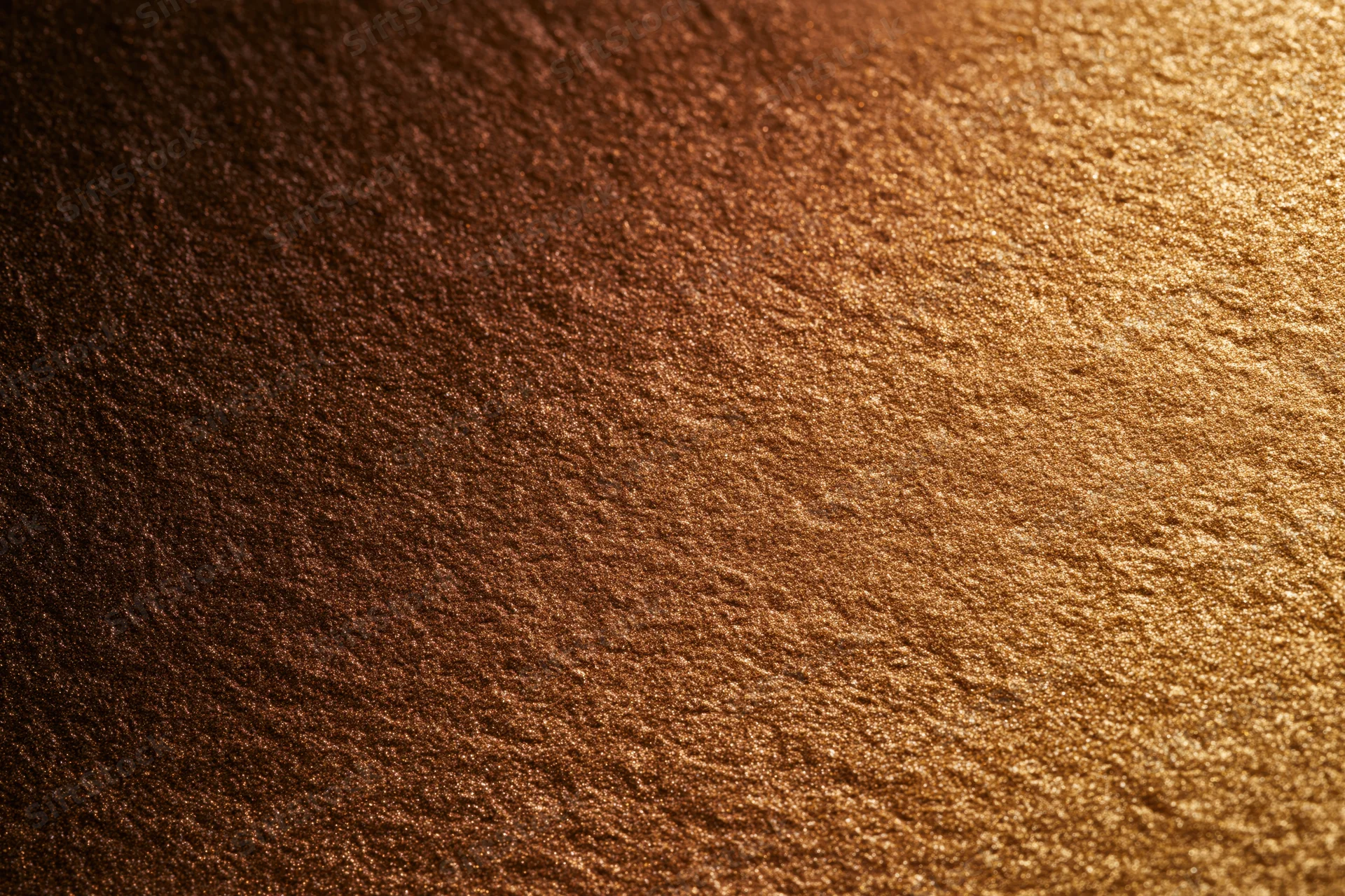 Close-up flat lay of a gold glitter-coated surface filling the frame with shimmering texture and reflective sparkle