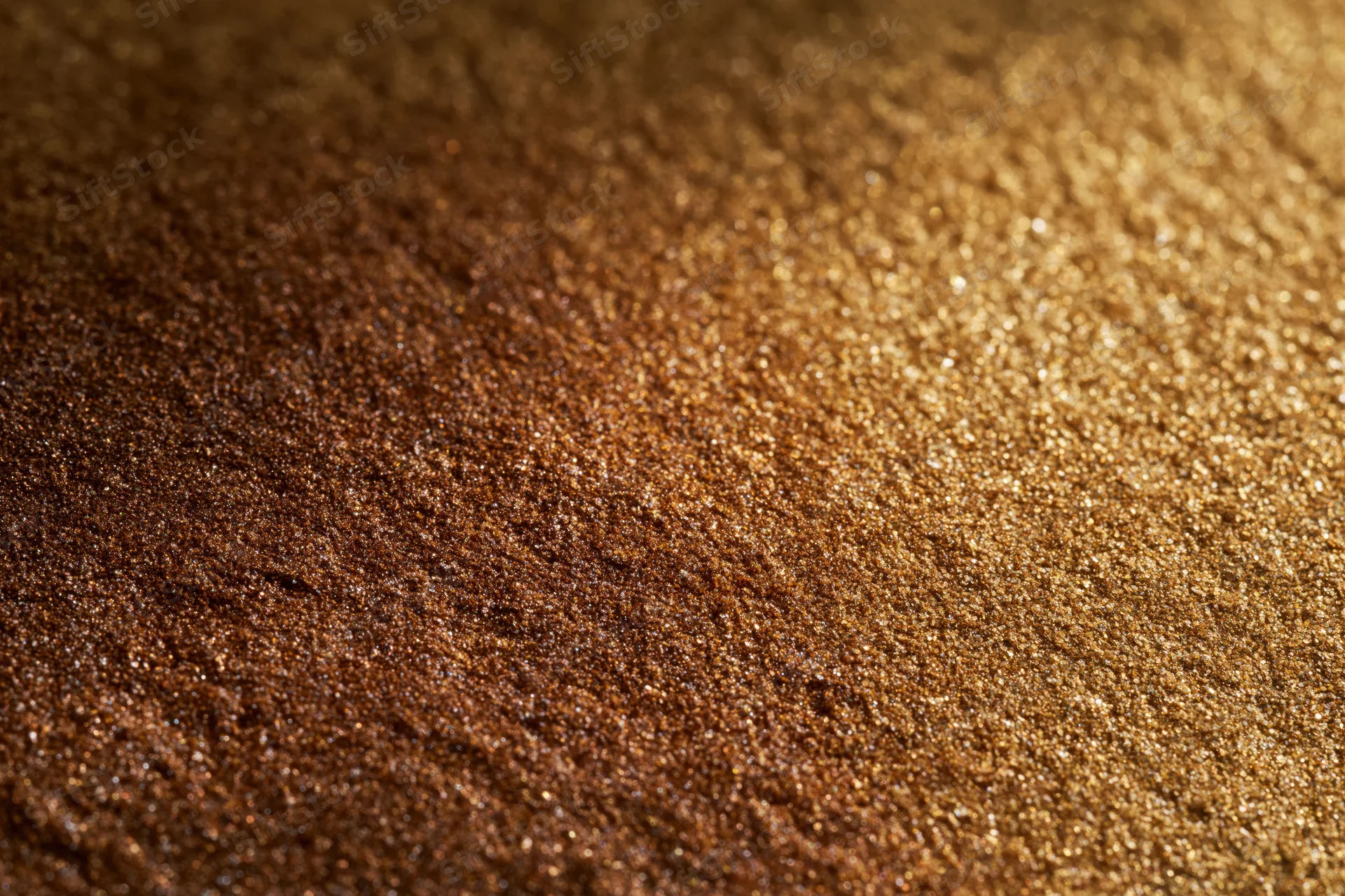 Gold glitter surface in close-up flat lay with warm gradient and sparkle