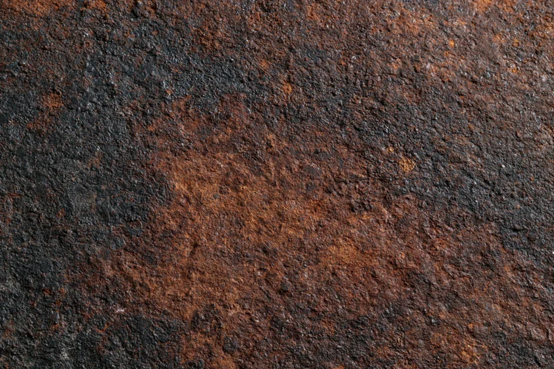 Close-up of heavily oxidized metal surface showing rust and corrosion texture