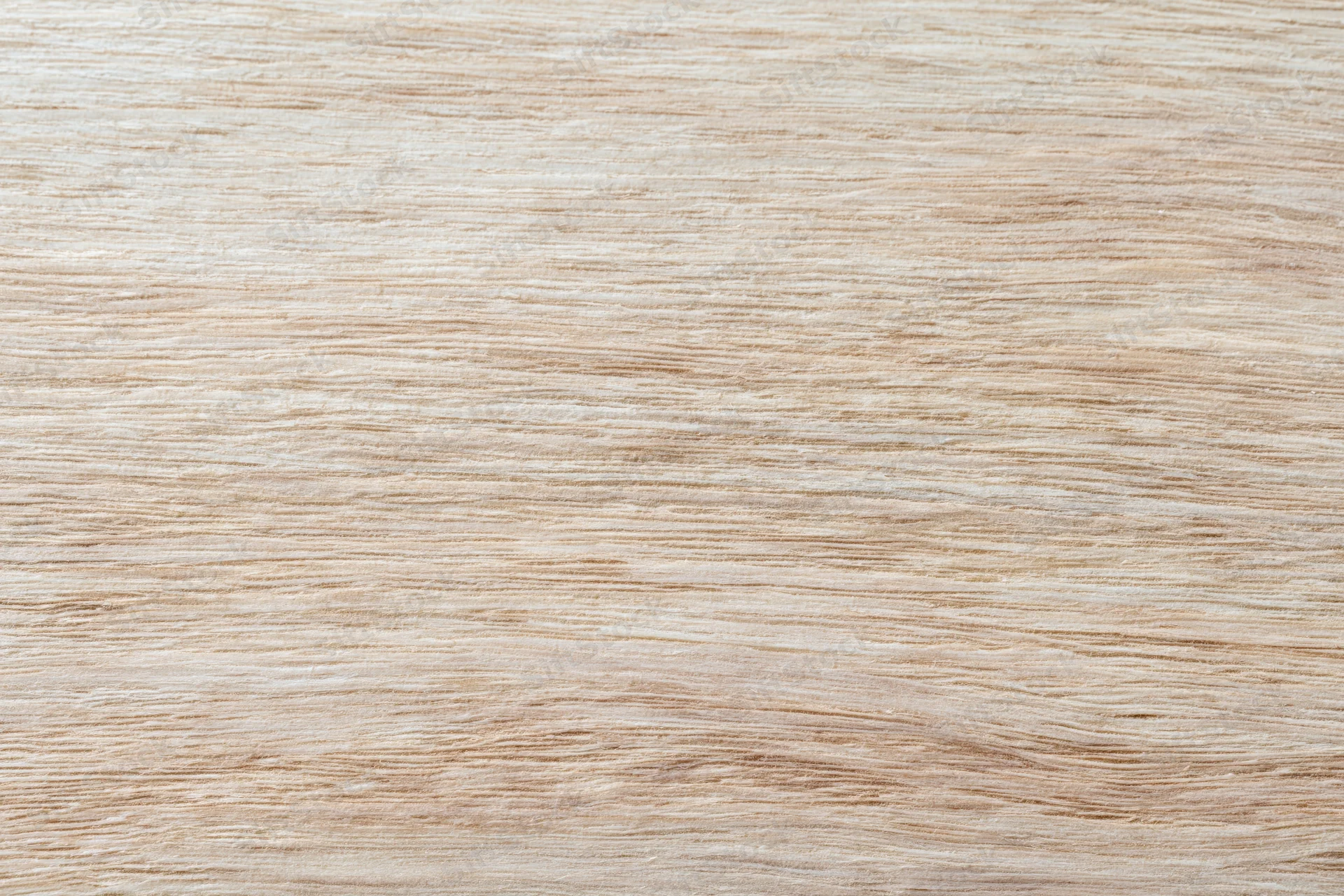 Close-up flat lay of a light bleached wood surface filling the frame with visible grain pattern