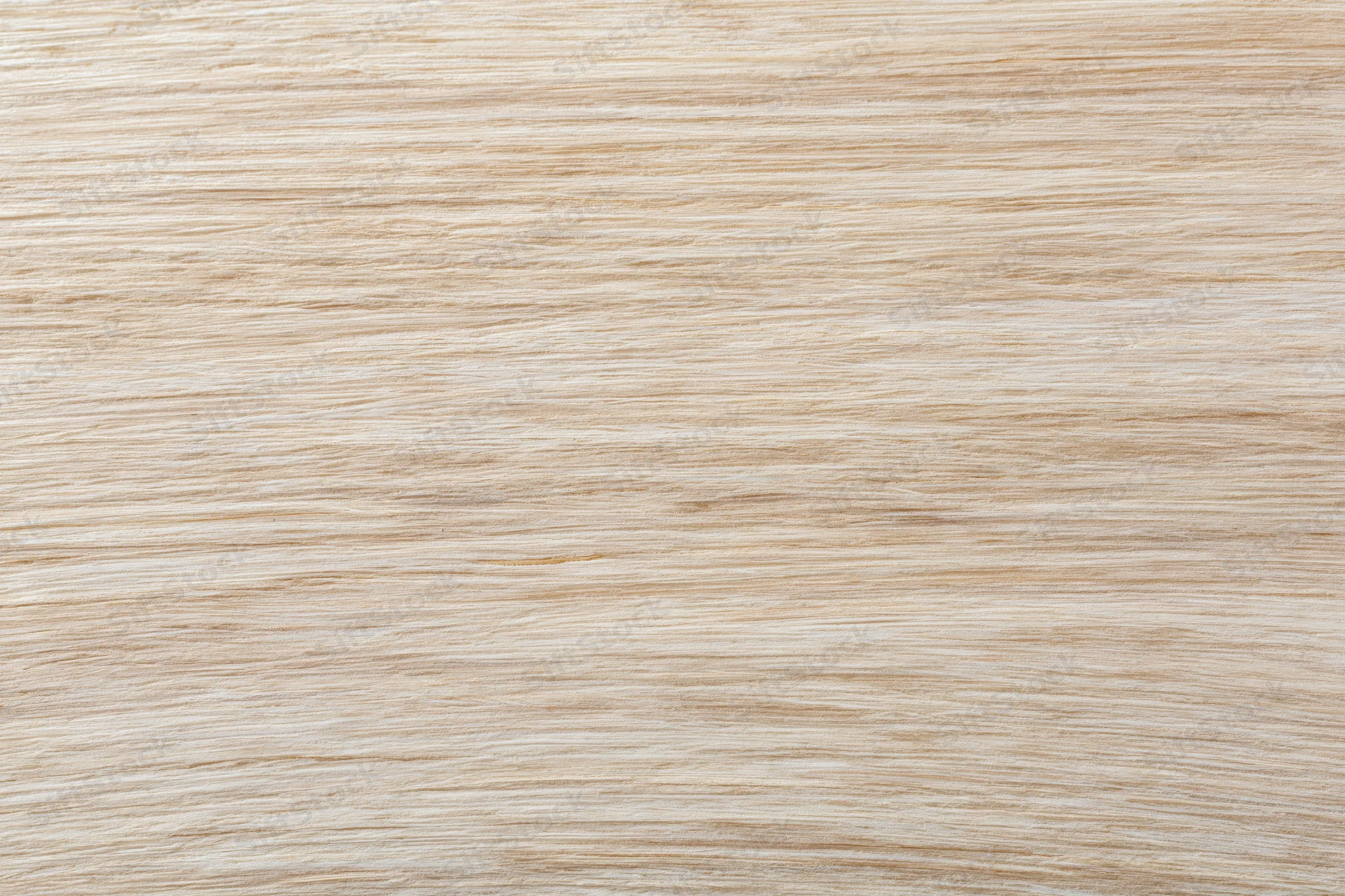 Close-up flat lay of a light bleached wood surface filling the frame with horizontal grain pattern