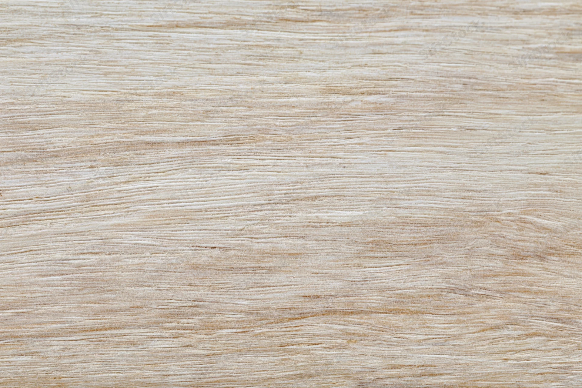 Close-up flat lay of a light bleached wood surface filling the frame