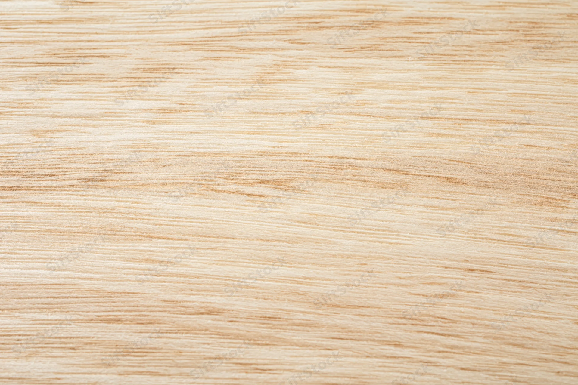 Close-up flat lay of a light natural wood surface with fine straight grain pattern
