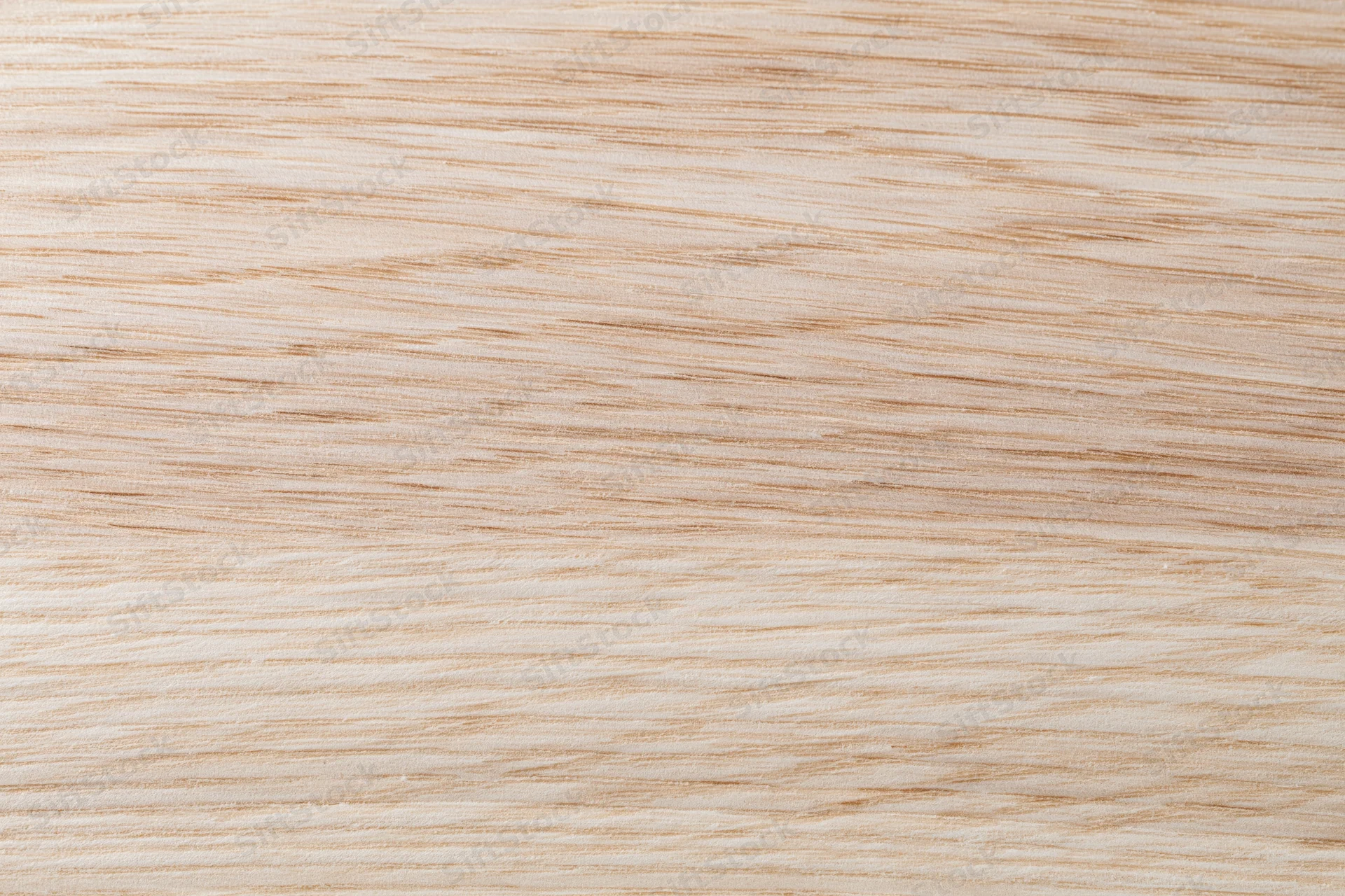 Close-up flat lay of a light natural wood surface with fine straight grain pattern