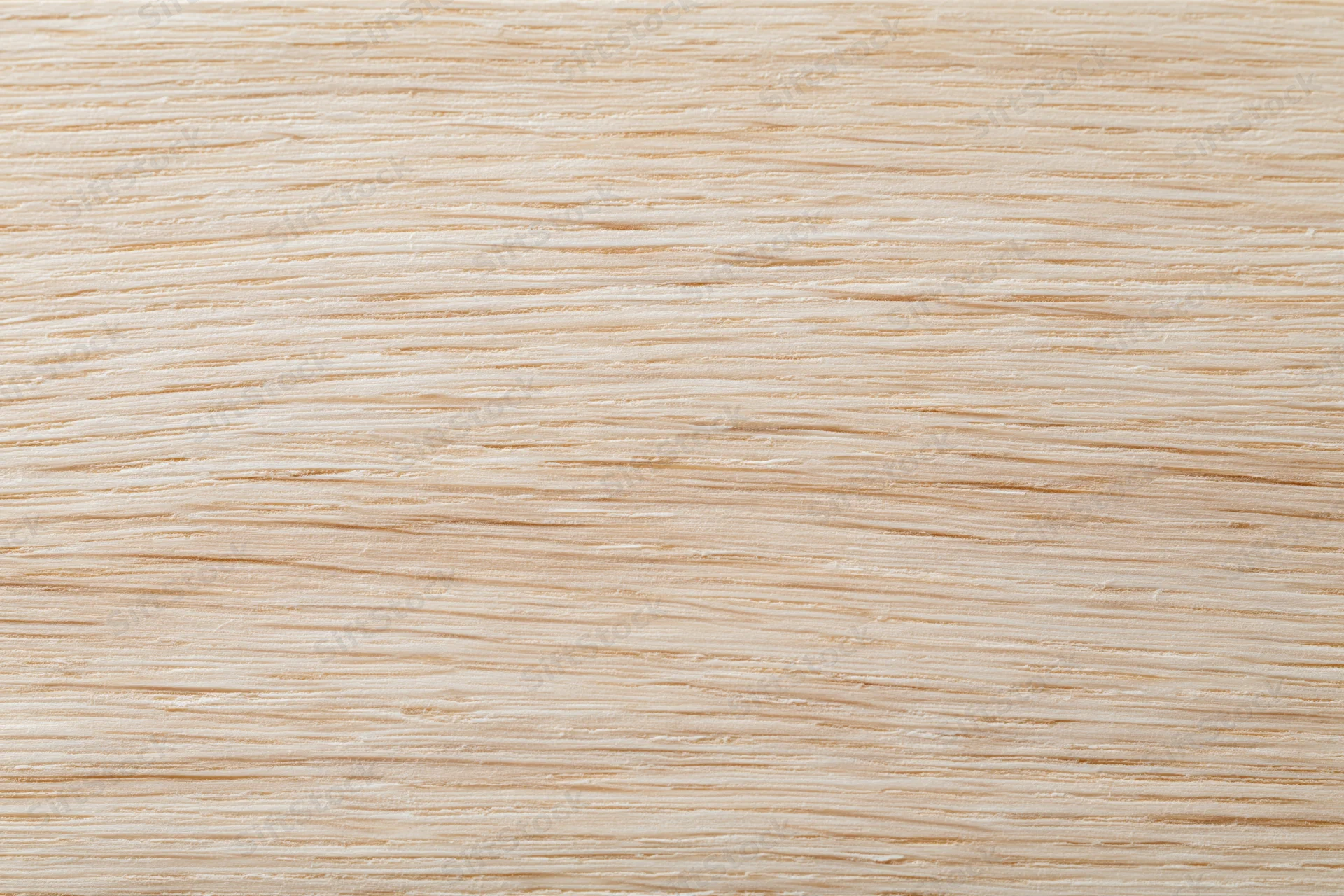 Close-up flat lay of a light natural wood surface with fine horizontal grain pattern