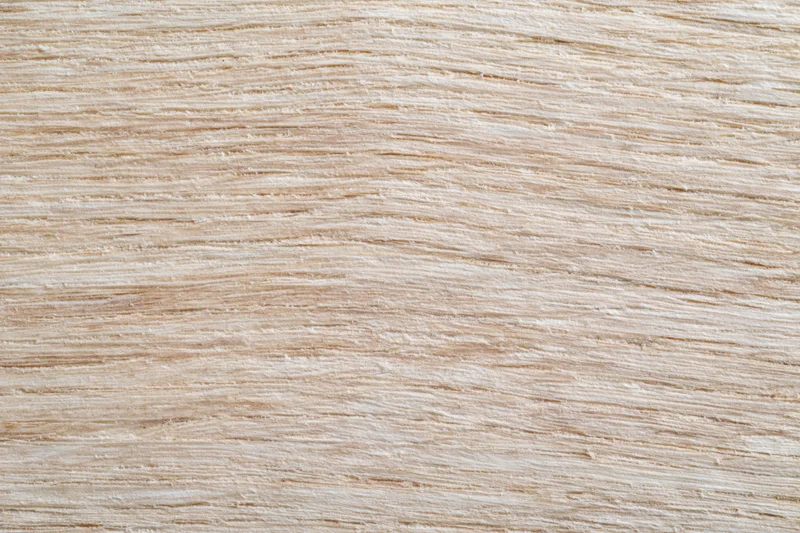 Close-up flat lay of light oak wood surface with horizontal grain pattern