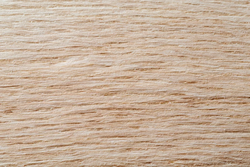 Close-up flat lay of light oak wood surface with horizontal grain pattern