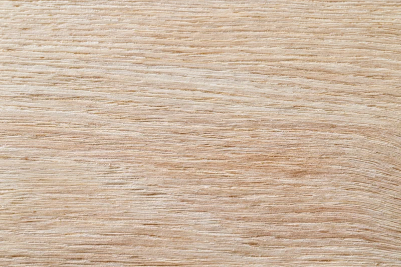 Close-up flat lay of light oak wood surface with horizontal grain pattern