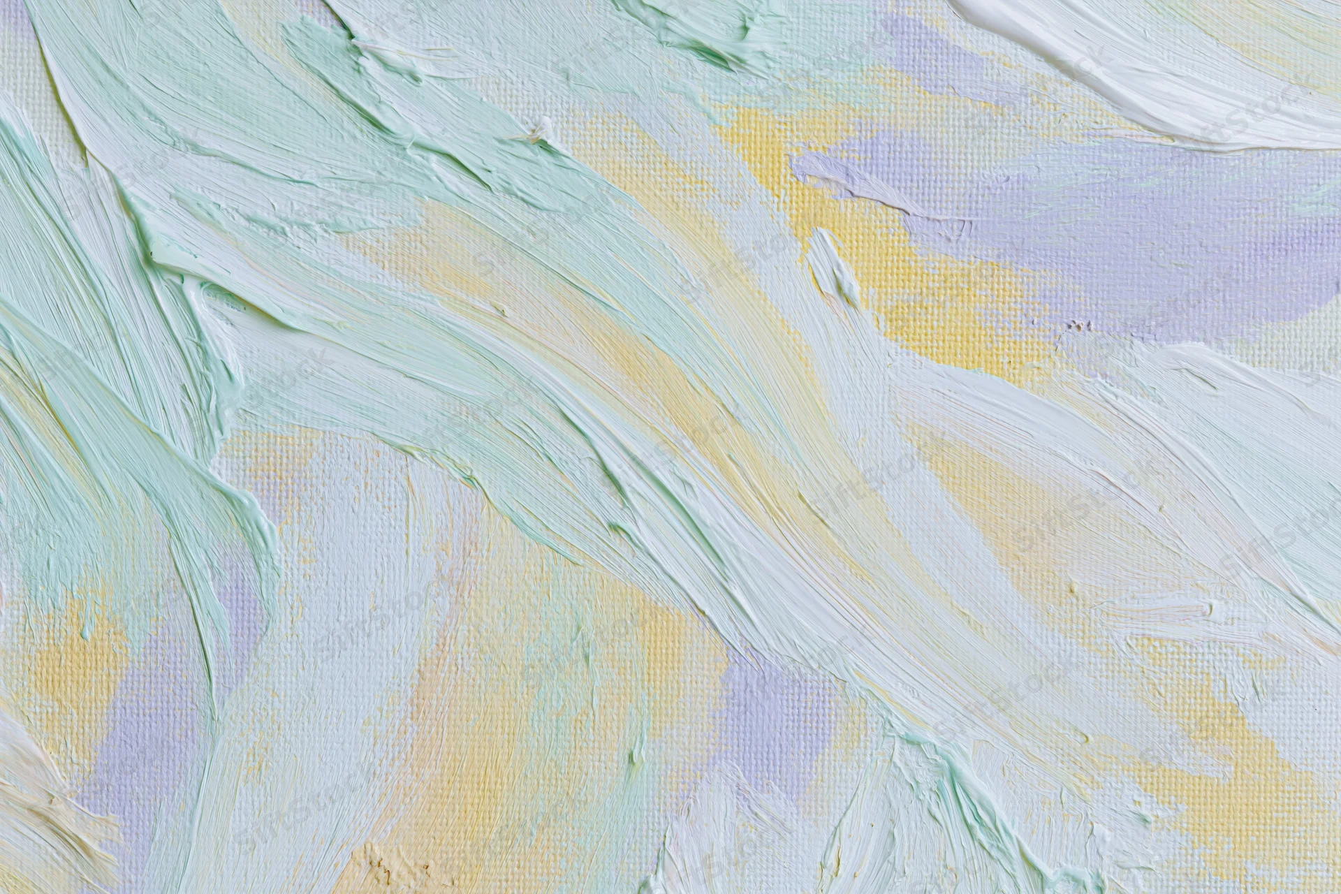Close-up of painted canvas surface with thick brushstrokes and pastel colors in abstract pattern