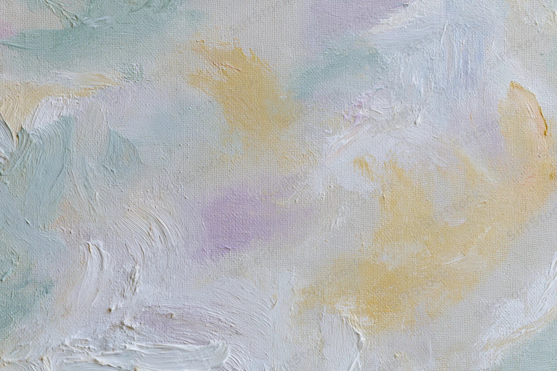 Close-up of painted canvas surface with textured brushstrokes in soft pastel colors