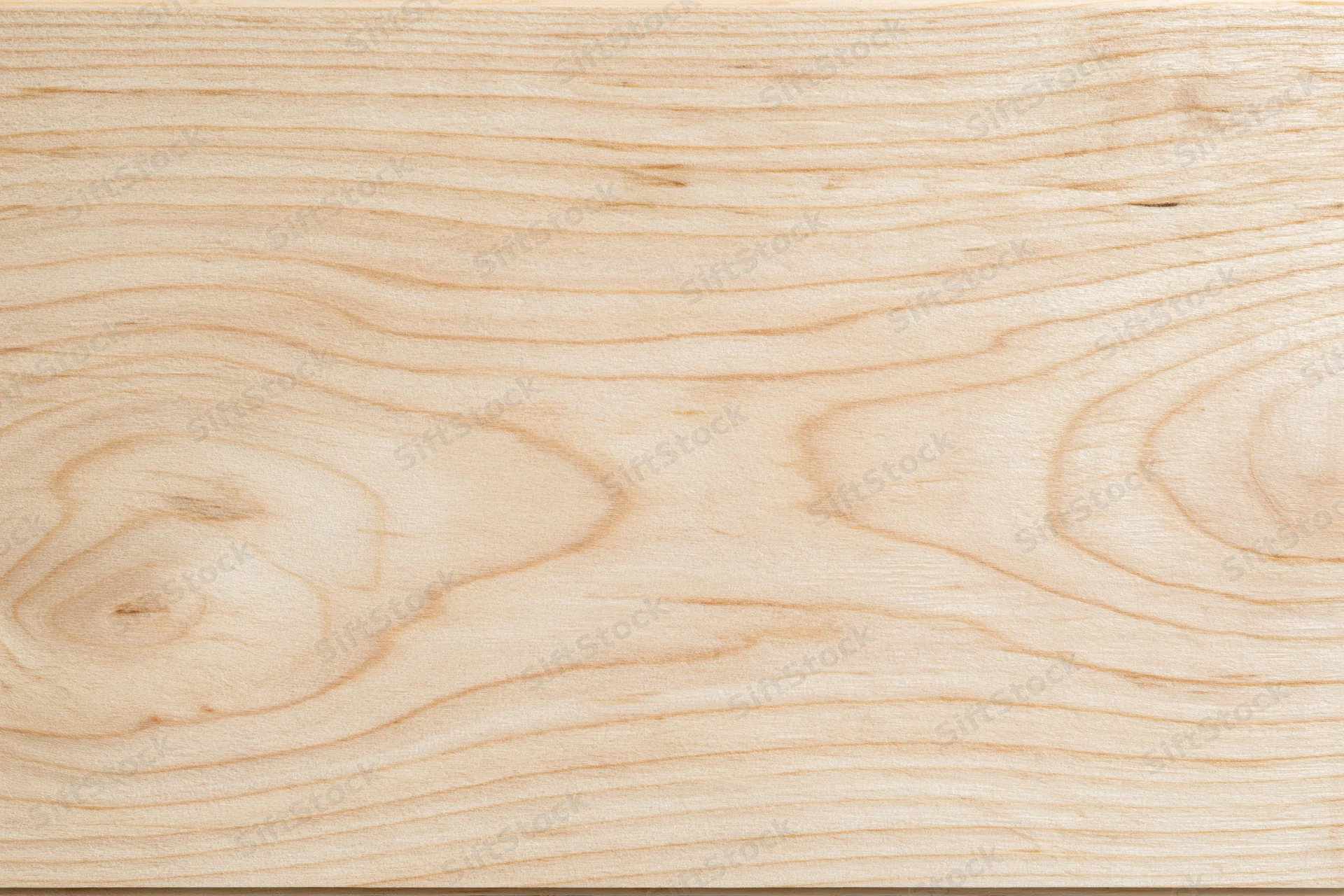 Close-up flat lay of a pale birch wood surface filling the frame