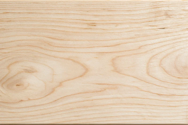 Close-up flat lay of a pale birch wood surface filling the frame