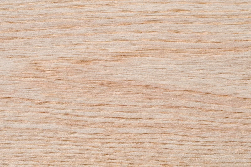 Close-up flat lay of a pale bleached wood surface filling the frame