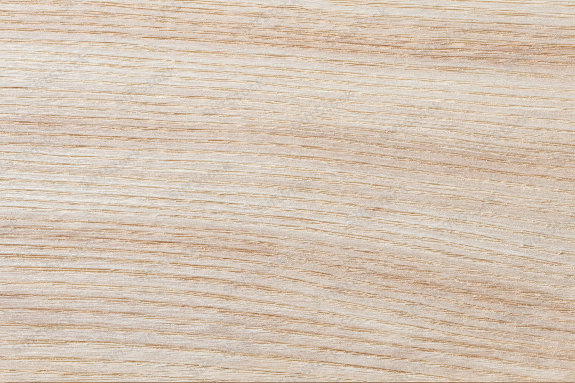Close-up flat lay of a pale bleached wood surface filling the frame