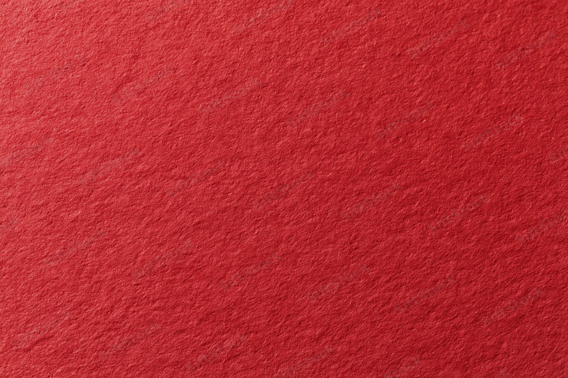 Close-up flat lay of red cardstock surface showing texture and grain