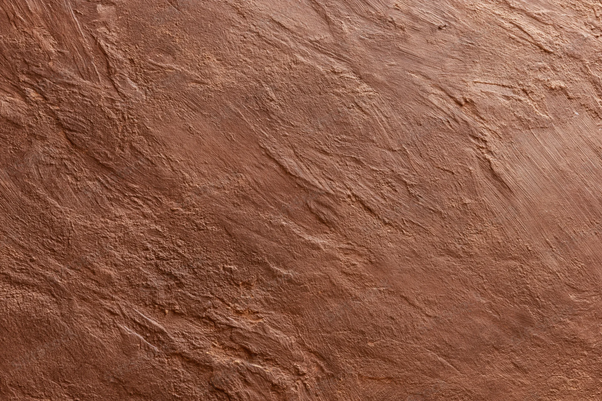 Close-up of rough stucco wall surface with visible texture and grain