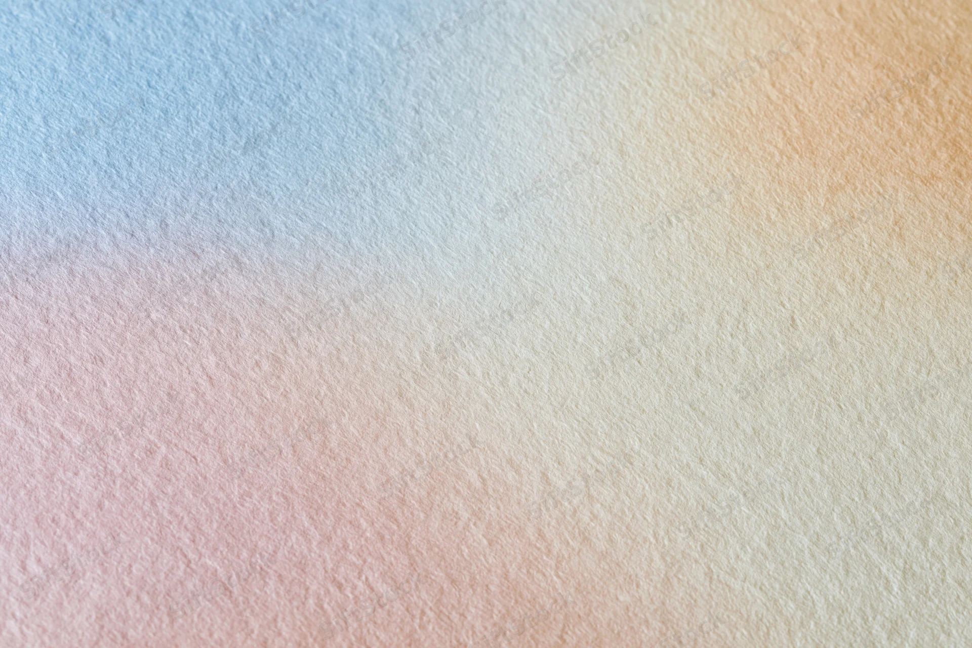 Close-up flat lay of a smooth matte paper surface with a soft pastel color gradient background