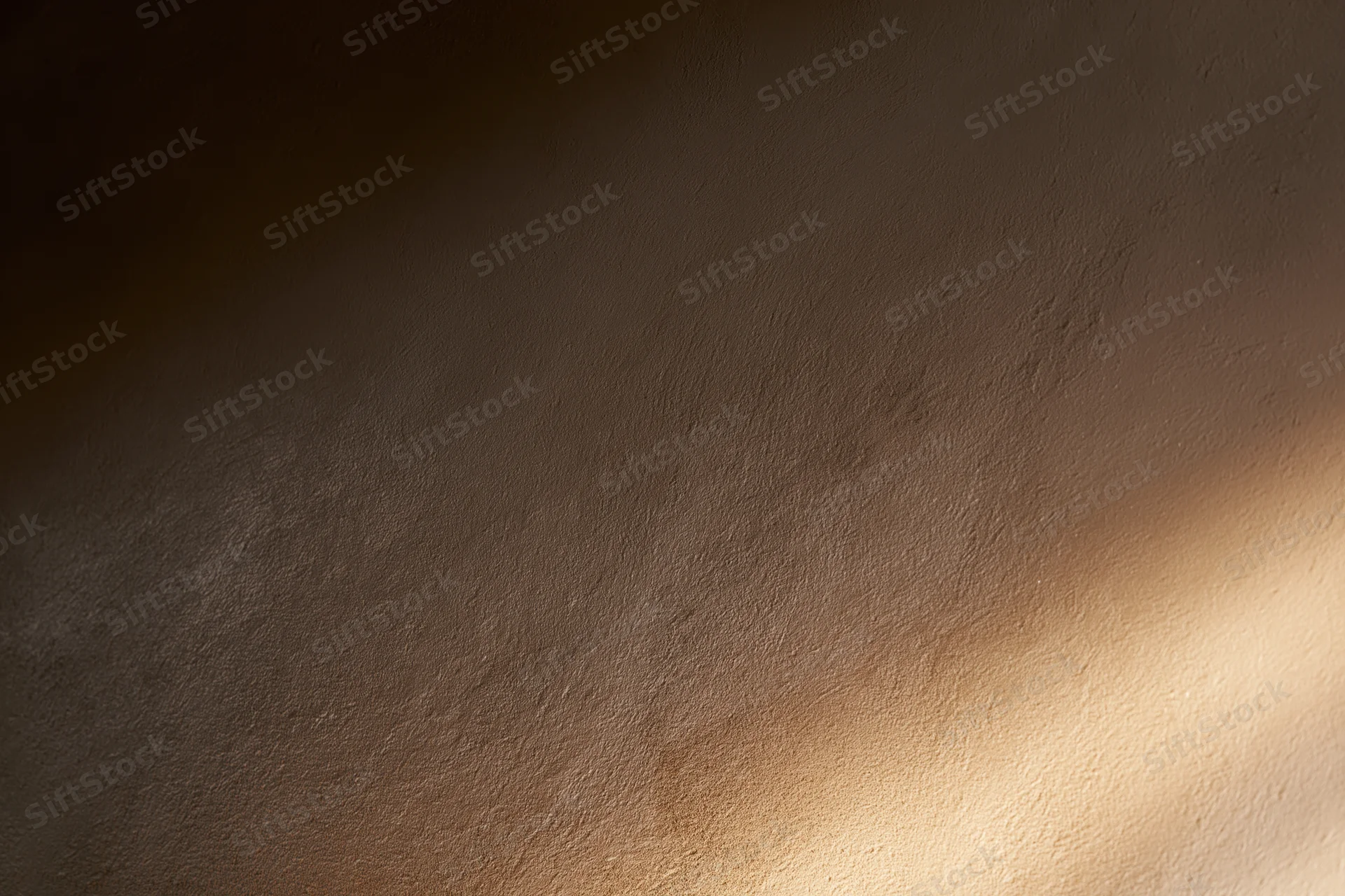 Close-up of a smooth plastered wall surface with soft light and shadow gradient