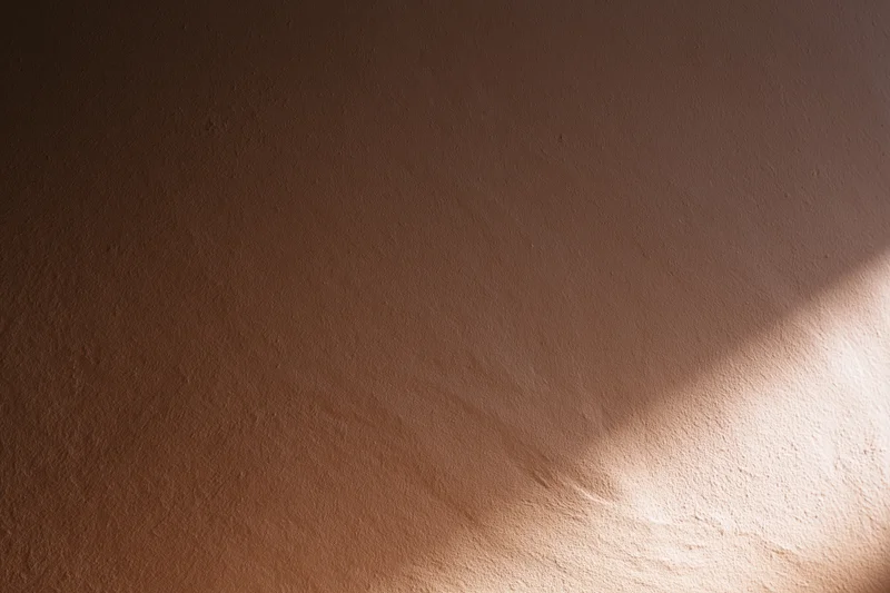 Smooth plastered wall surface with light and shadow in interior space