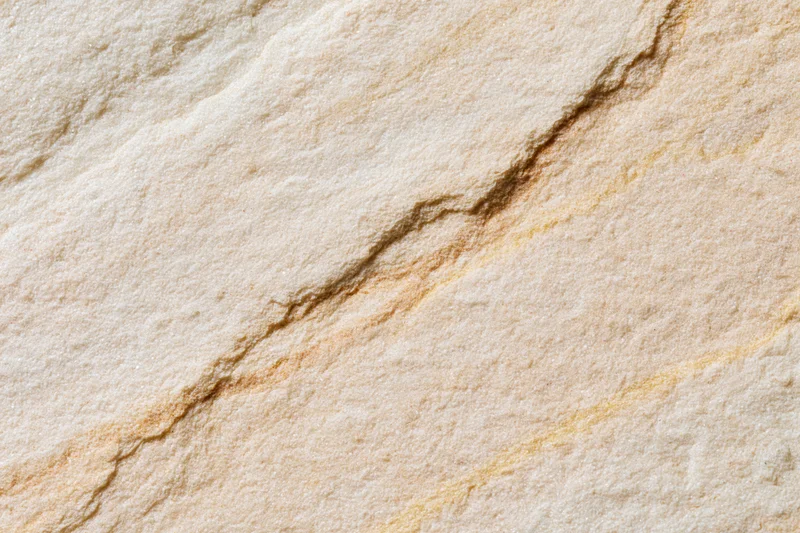 Close-up of a smooth sandstone surface with natural veining and cracks