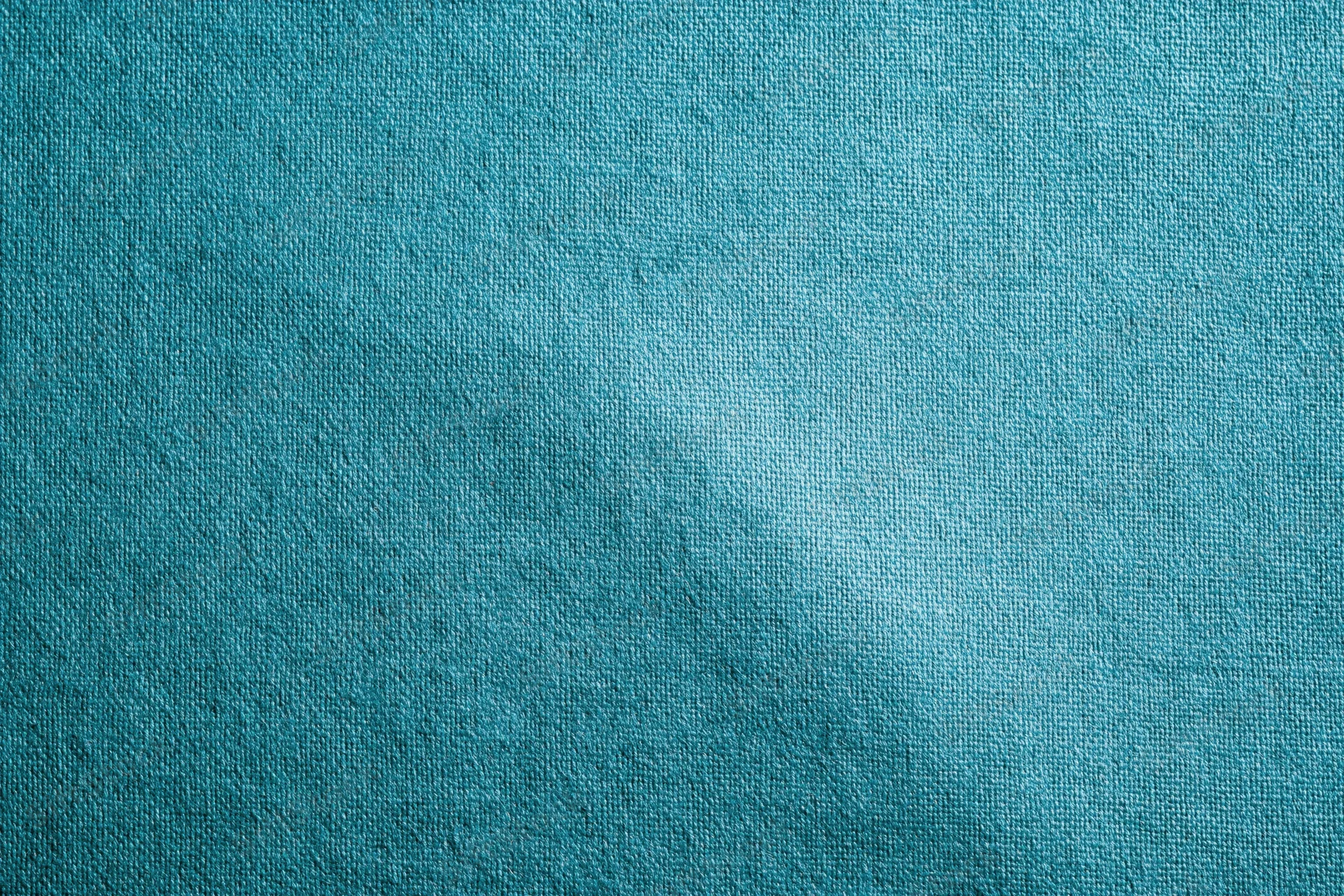 Teal-turquoise fabric surface in flat lay closeup filling frame