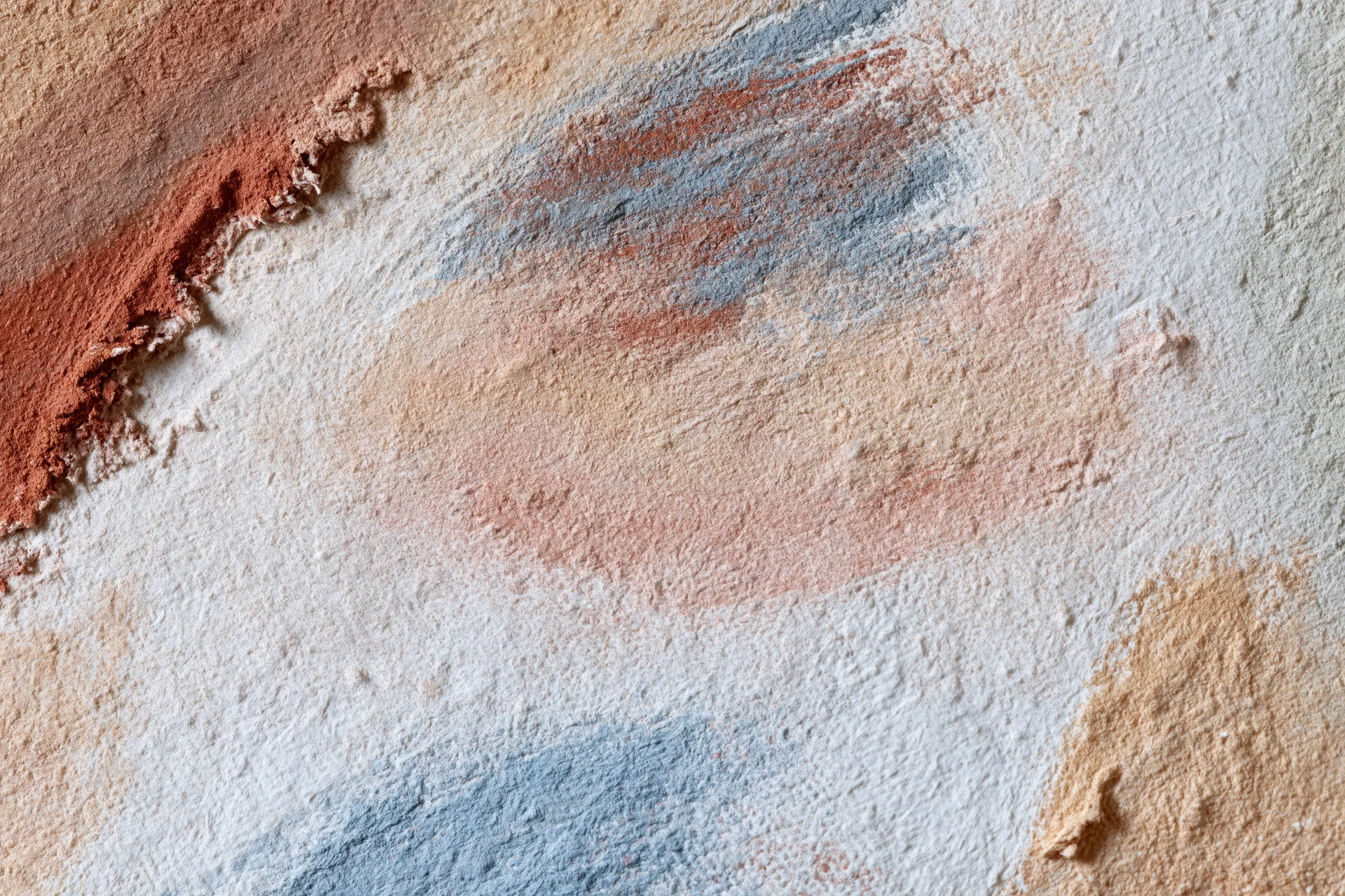 Textured painted canvas surface with layered brushstrokes and blended colors in a flat lay arrangement