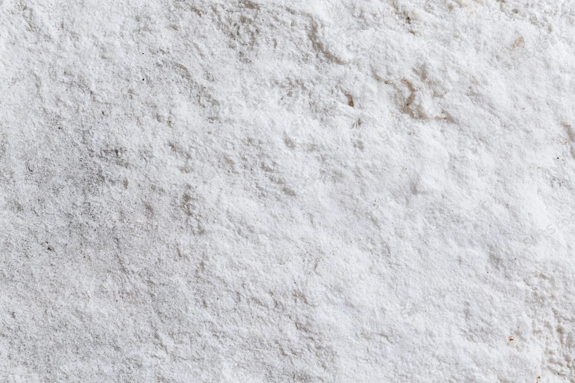 Weathered white concrete surface with rough texture and cracks, flat lay view