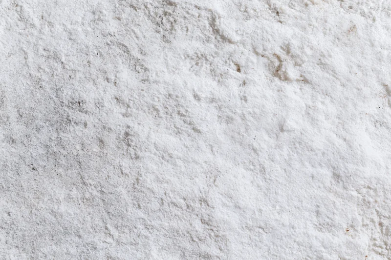 Weathered white concrete surface with rough texture and cracks, flat lay view