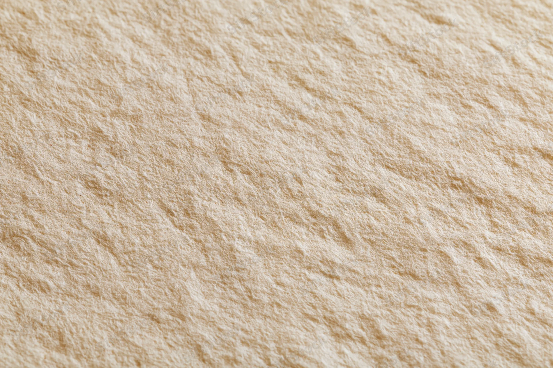 Close-up flat lay of aged cream paper surface with slight texture