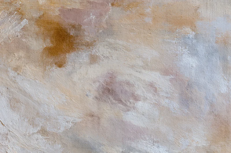 Close-up of abstract painted canvas surface with textured brushstrokes in beige and white tones