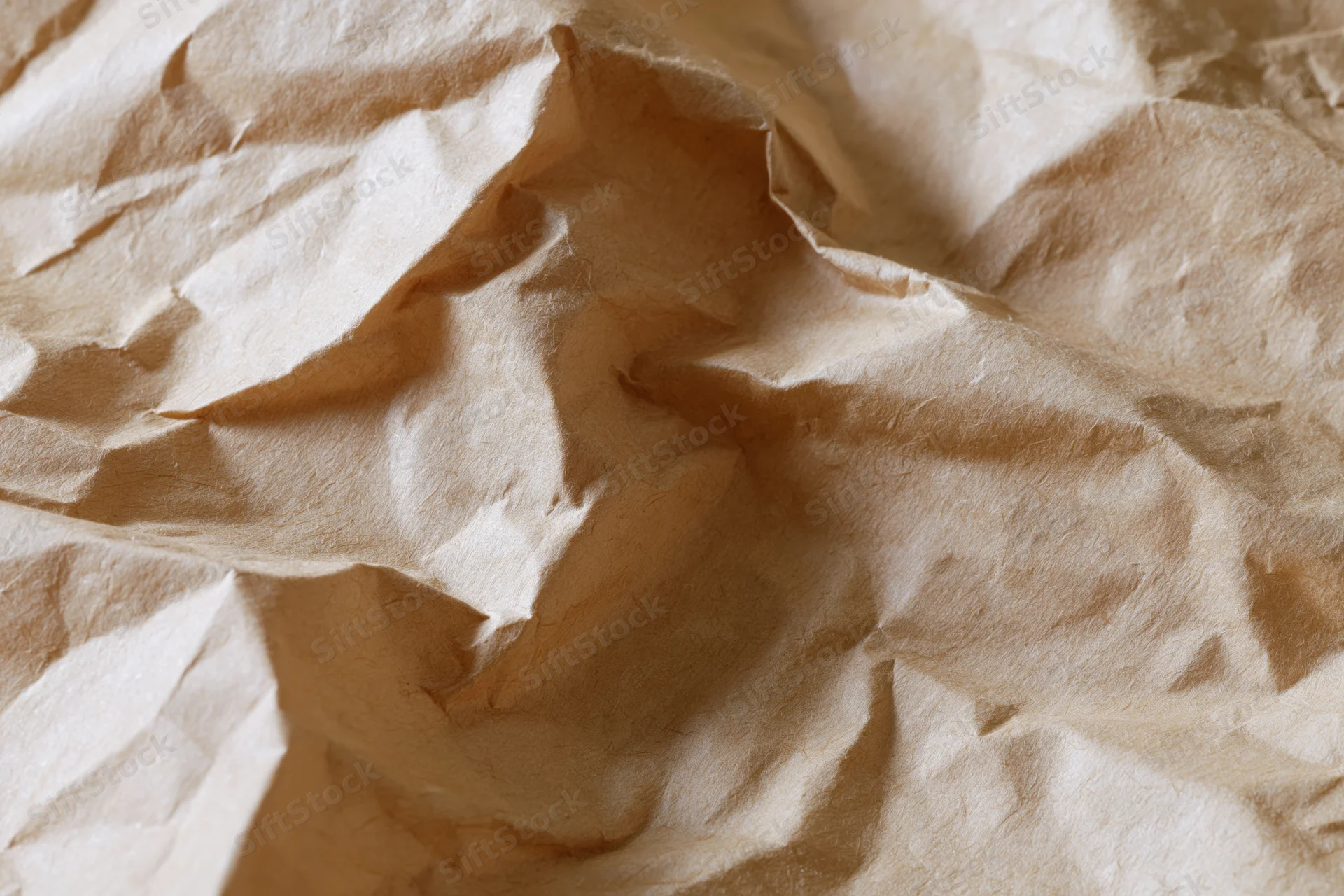 Crumpled kraft paper filling the frame in a flat lay closeup
