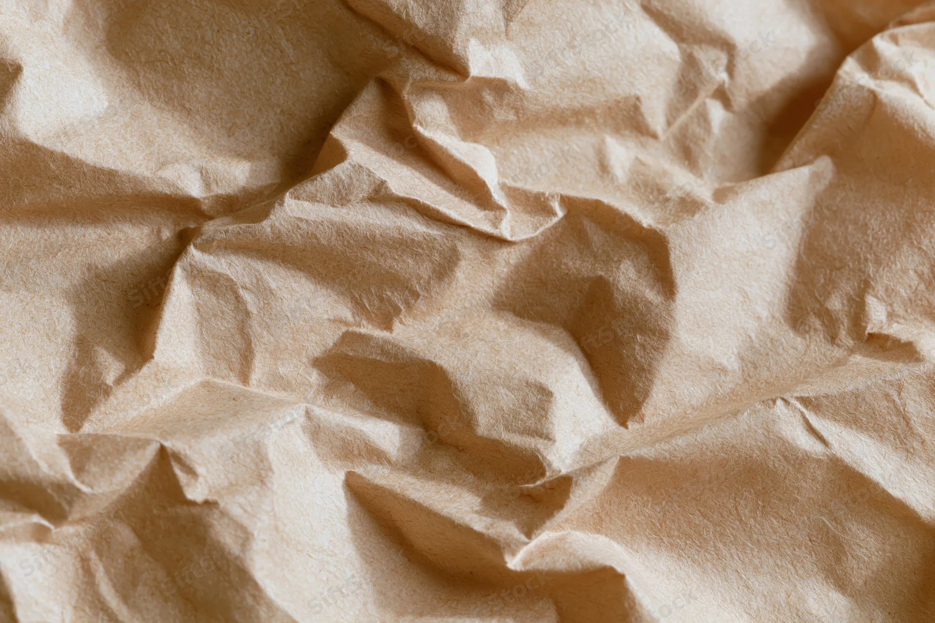 Crumpled kraft paper filling the frame in a flat lay close-up view