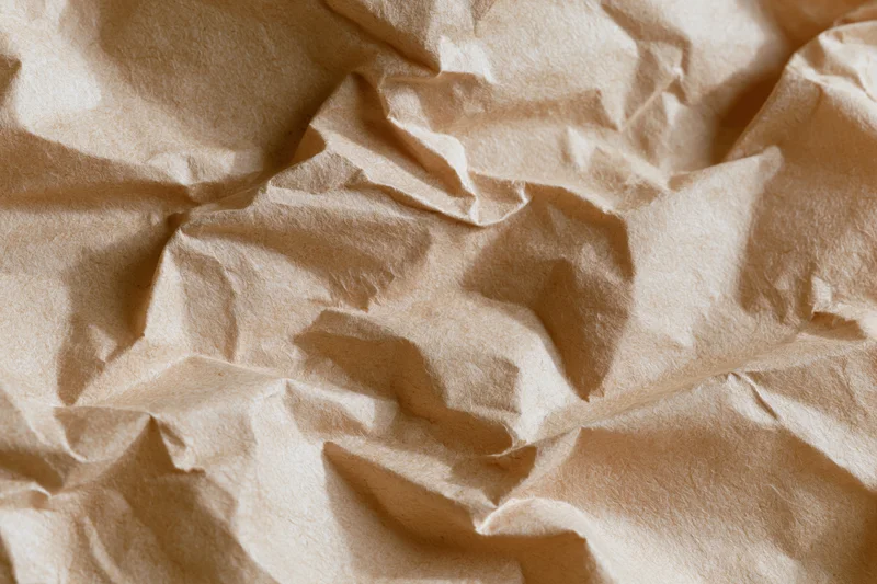 Crumpled kraft paper filling the frame in a flat lay close-up view