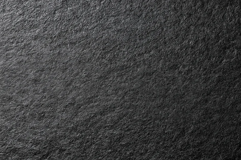 Close-up flat lay of dark black textured paper surface