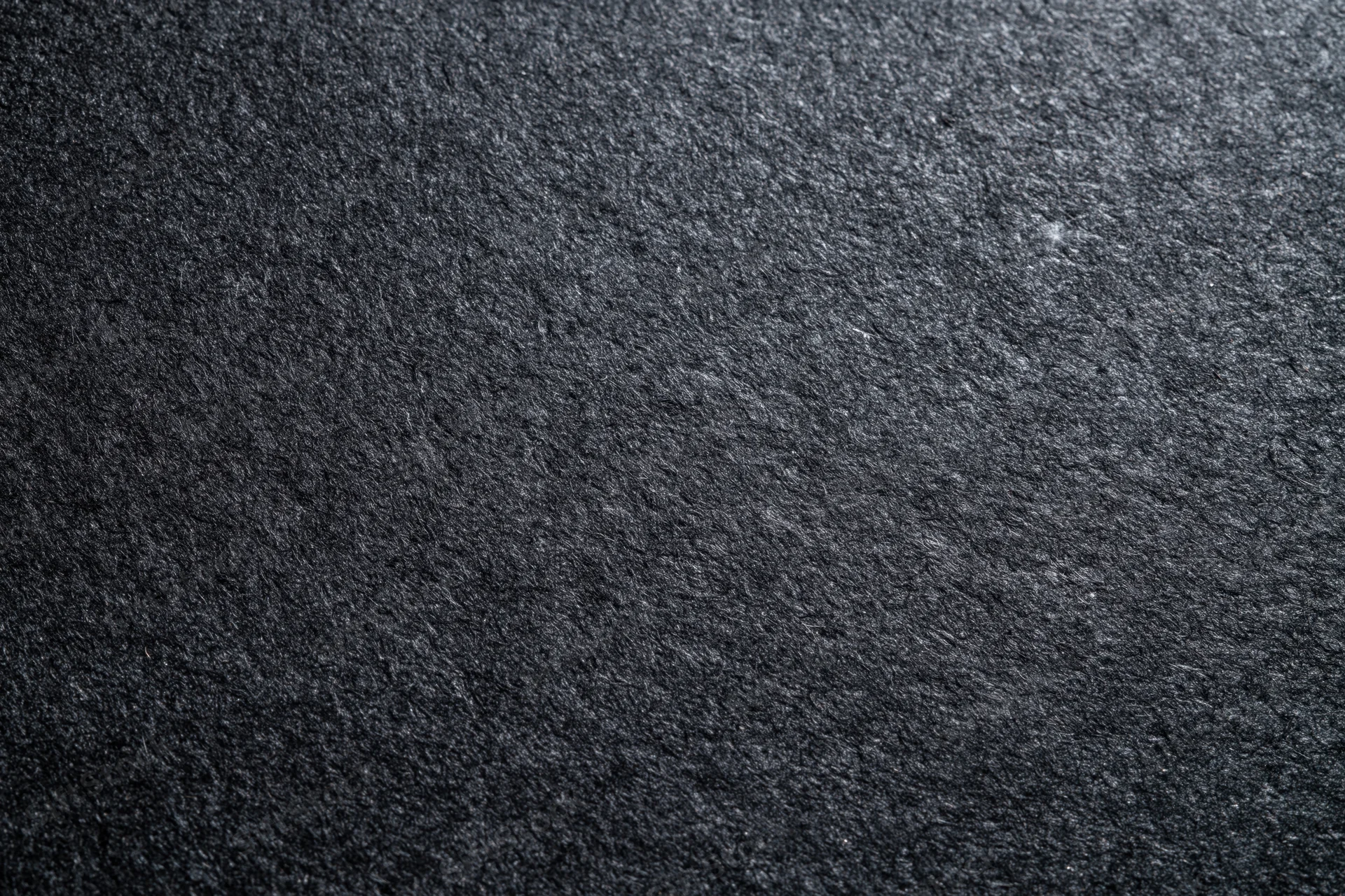 Close-up flat lay of dark black textured paper surface