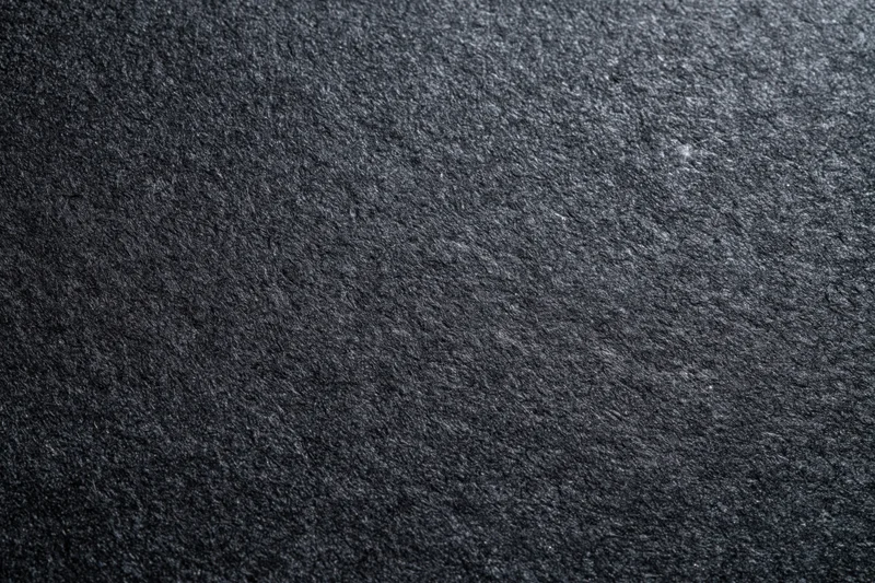 Close-up flat lay of dark black textured paper surface
