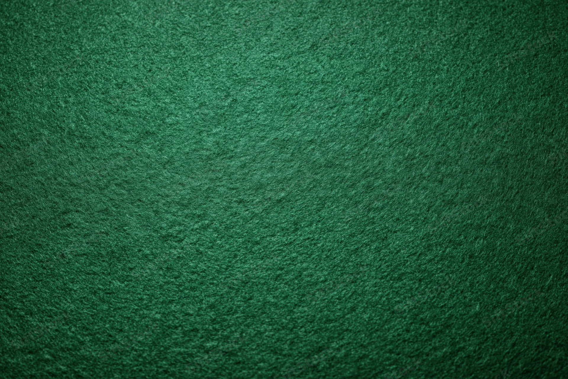 Green casino felt fabric filling the frame in a flat lay close-up
