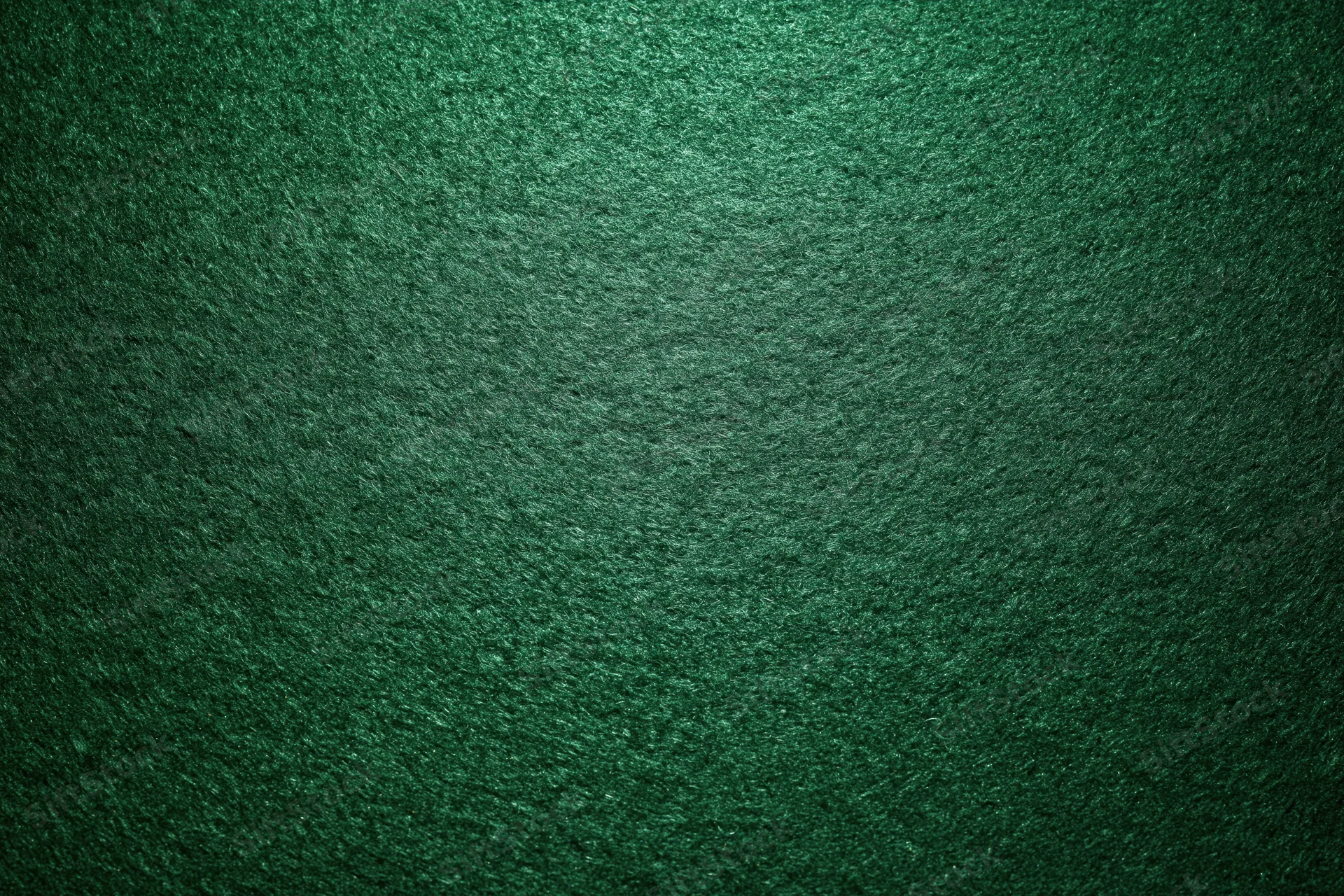 Green casino felt fabric filling the frame in a flat lay close-up view