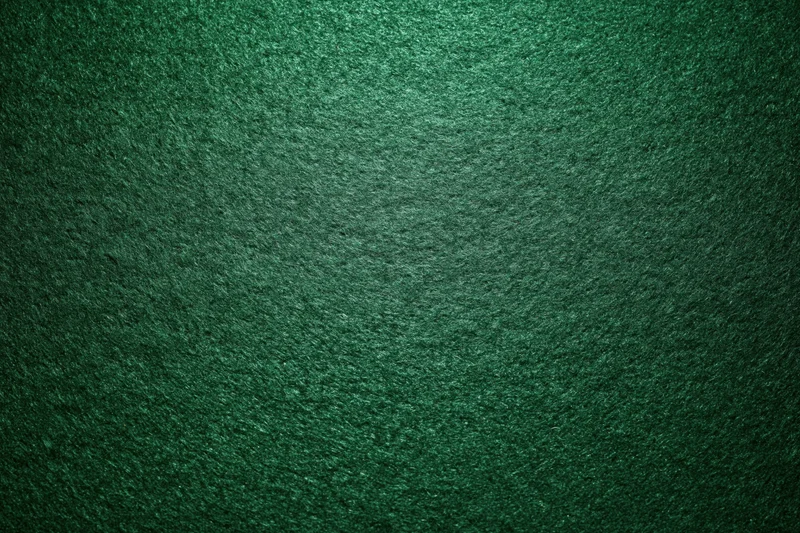 Green casino felt fabric filling the frame in a flat lay close-up view
