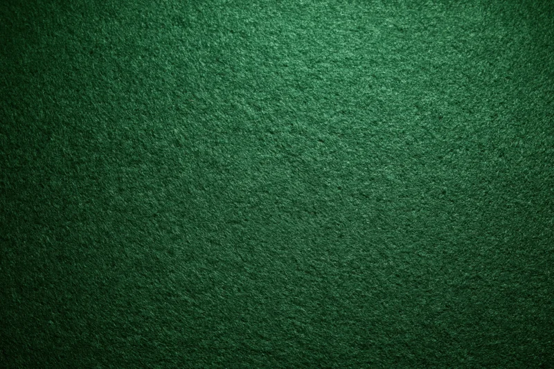 Close-up flat lay of green casino felt fabric filling the frame