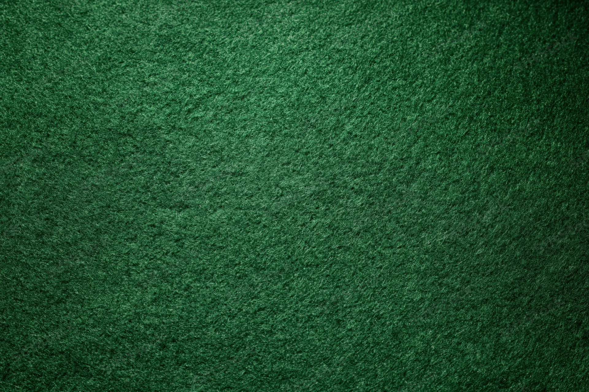 Green casino felt fabric filling the frame in a flat lay close-up view