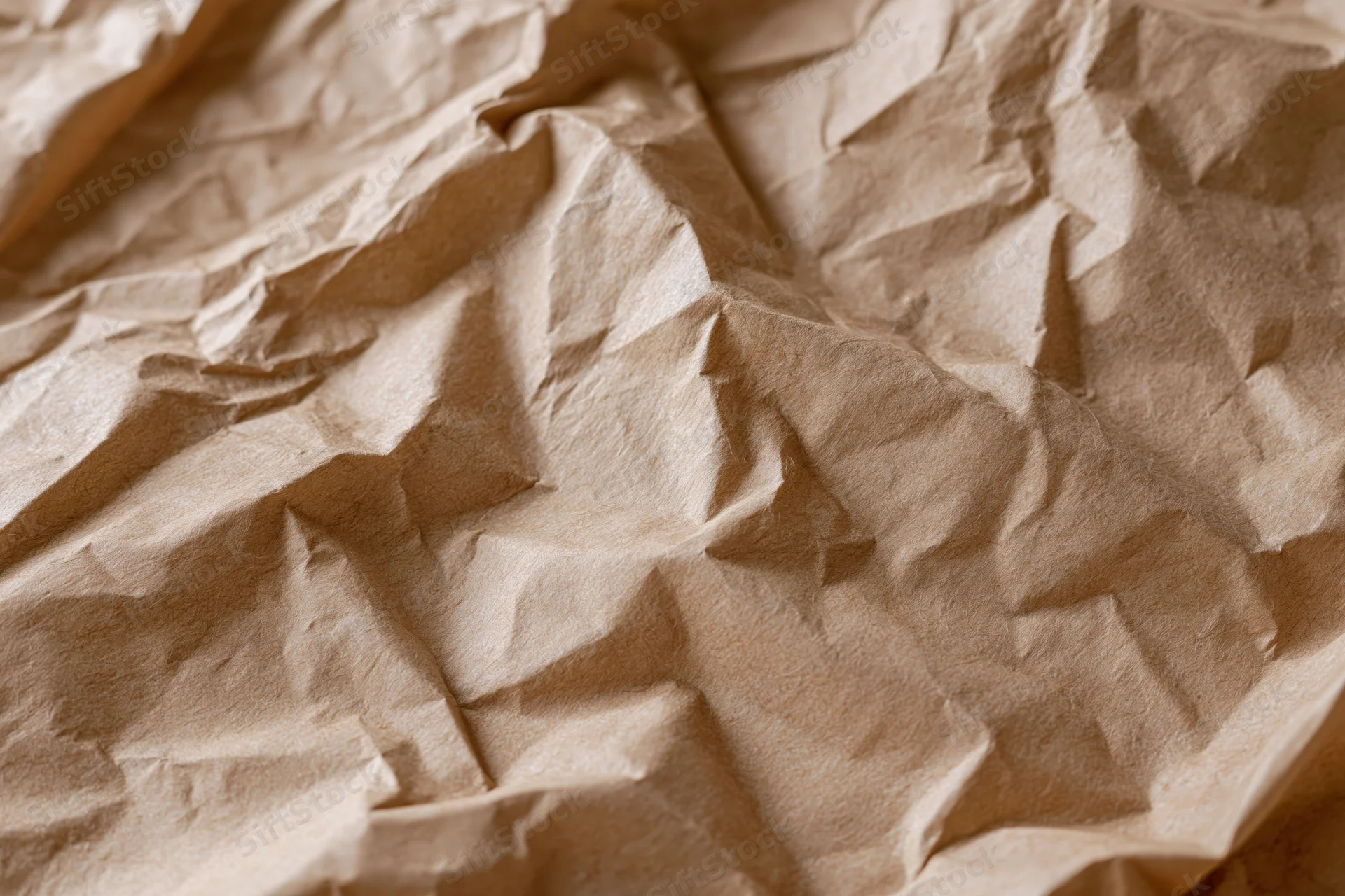 Crumpled brown kraft paper laid flat as a textured surface
