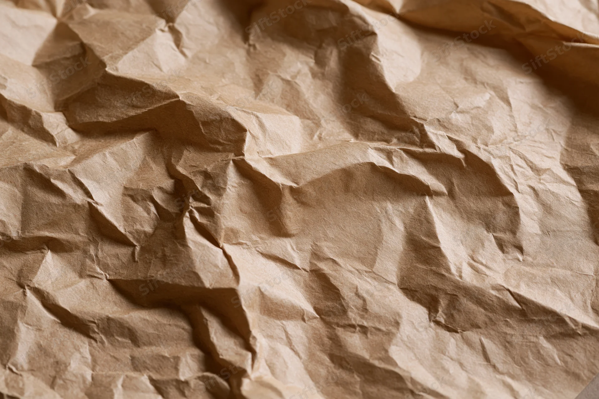 Crumpled brown kraft paper surface in flat lay closeup