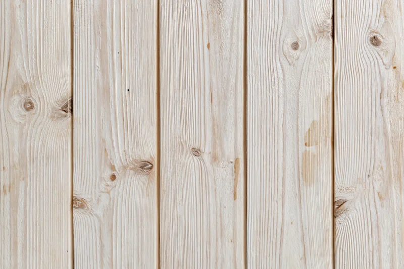 Pale bleached wood planks arranged vertically in a flat lay view filling the frame