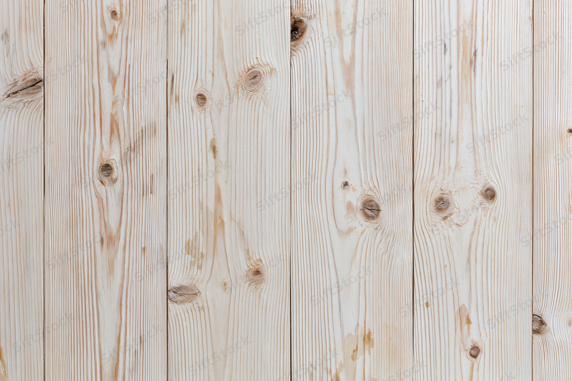 Pale bleached wood planks arranged vertically filling the frame as a textured background