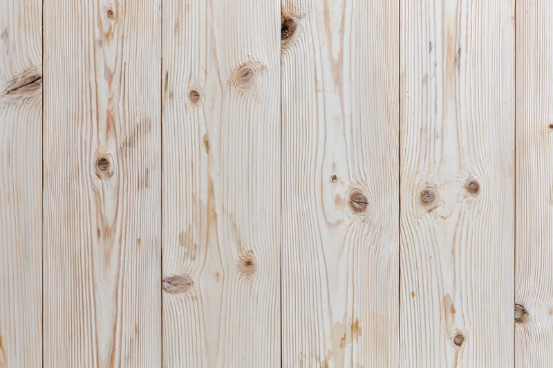 Pale bleached wood planks arranged vertically filling the frame as a textured background