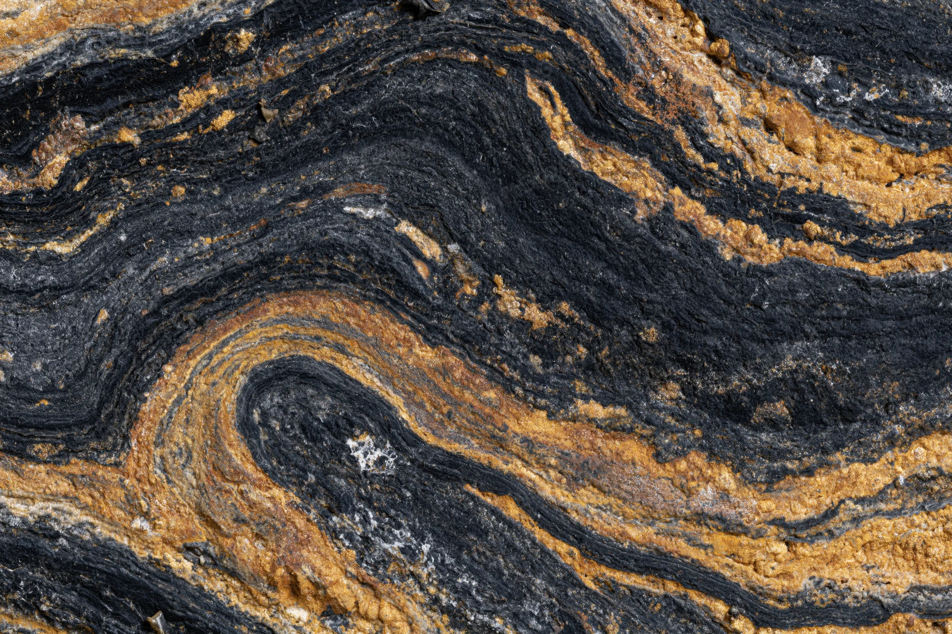 Polished black marble surface with gold veining and swirling natural patterns