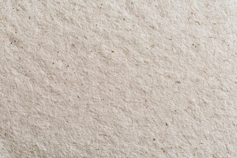 Close-up flat lay of recycled kraft paper surface filling the frame