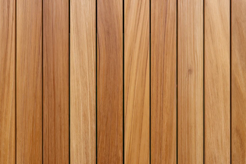 Vertical teak wood planks arranged in a flat lay forming a textured surface